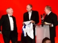 656410-07 : @Lionel Heap : News : A Question of Brains 2015 Charity Dinner in AId of Steps Conductive Education Centre in Shepshed : Auction... local sporting legends (from left) Peter Wheeler, Jonathan Agnew and Alan Birchenall auction a signed Jamie Vardy Leicester City shirt which helped towards raising £75,000 for Steps.